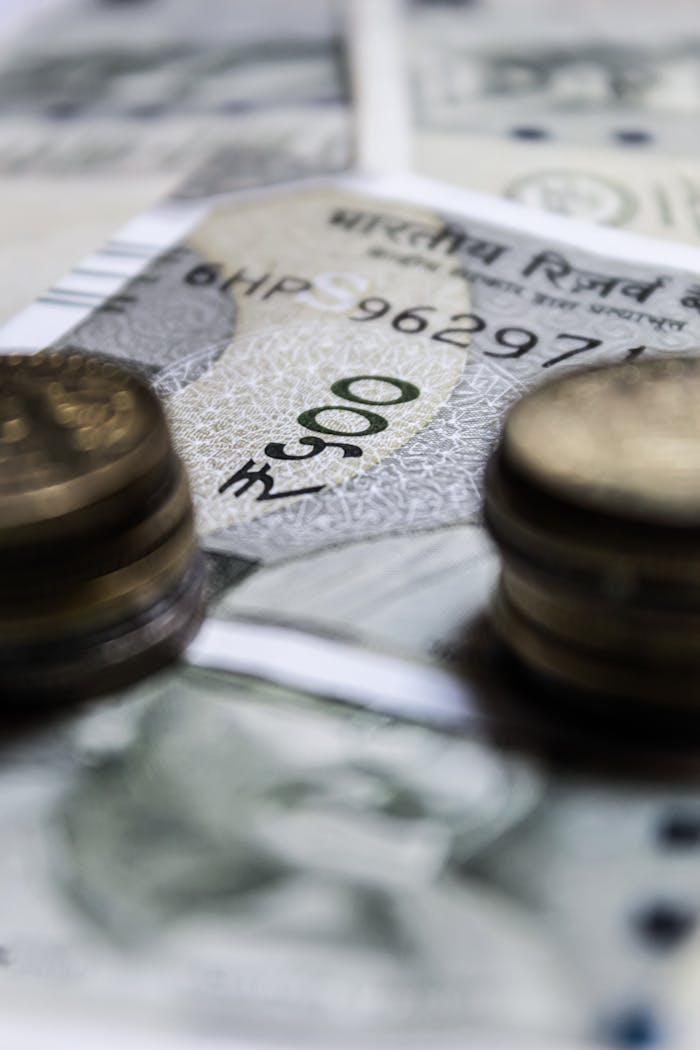 Macro view of Indian currency featuring rupees and coins, showcasing financial abundance.